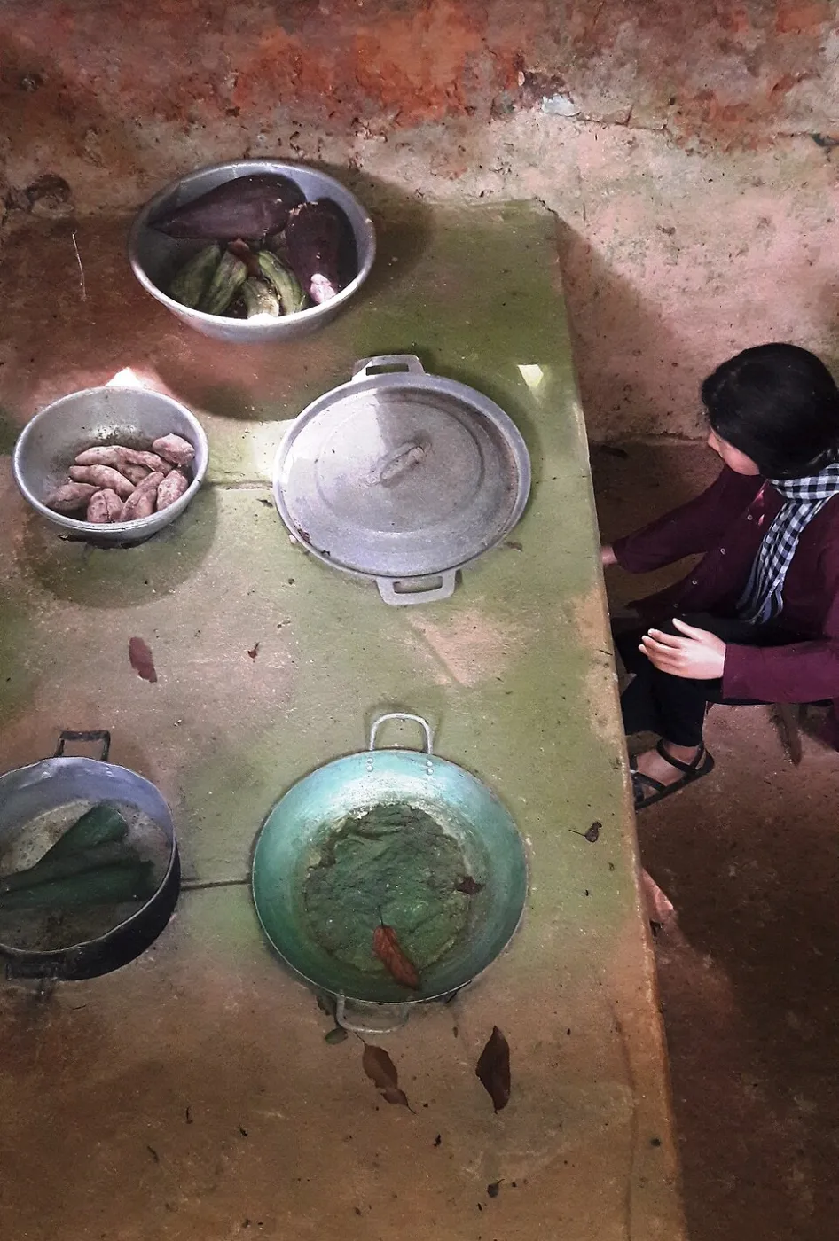 A reconstructed Hoang Cam stove dug into the ground, with cooking pots set over its fire holes, at a former Viet Cong base in southern Vietnam